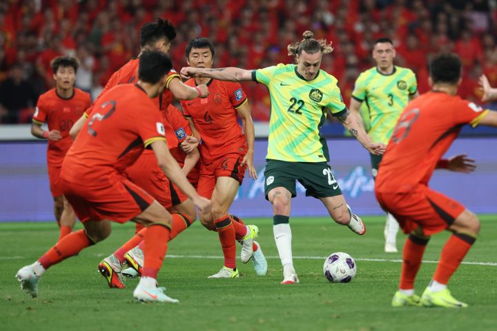 Jackson Irvine surrounded by Chinese national team players during Australia's World Cup qualifying match against China in Hangzhou.